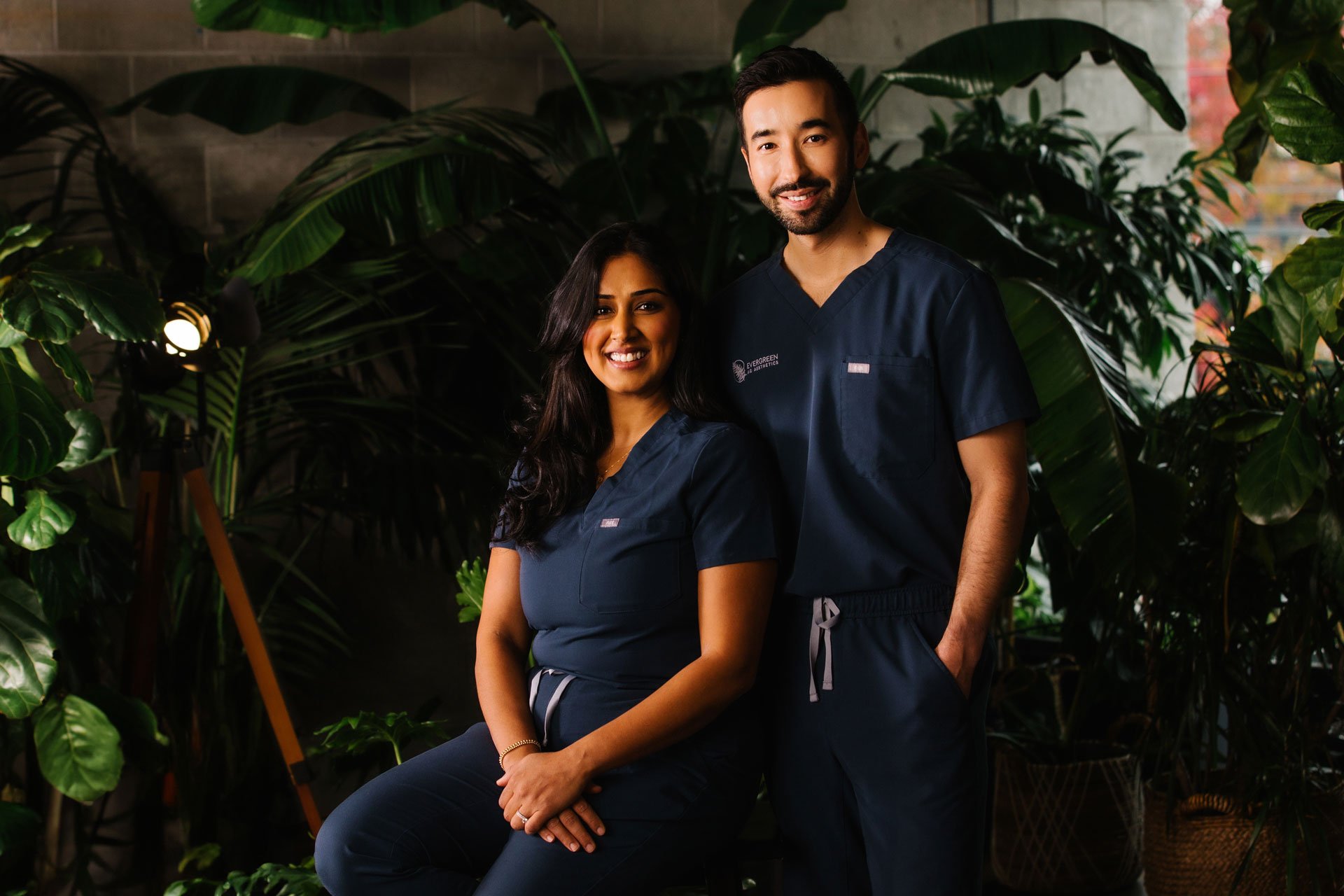 Dr. Robert Dale and Dr. Supreet Maan in front of an assortment of dark green plants.